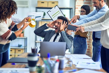 Group of business workers working together. Partners stressing one of them at the office