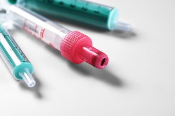 Three Syringes without needles over grey background
