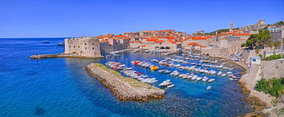 DUBROVNIK, CROATIA - JULY 13 2019: Aerial panorama with old city defense walls, harbor and Kase...