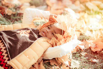 happy little child, baby girl laughing and playing in the autumn on the nature walk outdoors.