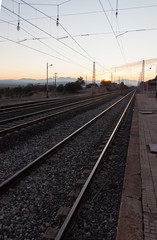 Fototapeta na wymiar sunset on the train tracks in Avila, Spain