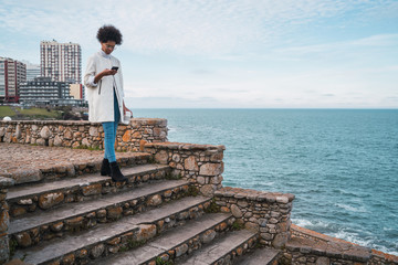 Young woman using her mobile phone.