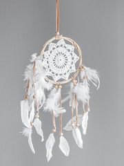 White dreamcatcher at gray background. Interior decoration. Native American Dreamcatcher