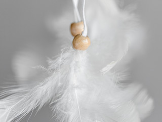 Plumage and beads of a Native American Dreamcatcher. Close up. Selective focus.