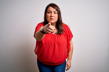 Beautiful brunette plus size woman wearing casual red t-shirt over isolated white background pointing displeased and frustrated to the camera, angry and furious with you