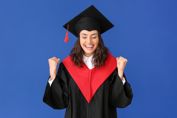 Happy female graduating student on color background