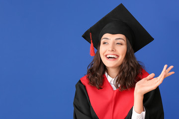 Female graduating student on color background