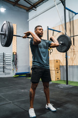 Crossfit athlete doing exercise with a barbell.