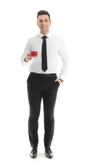Handsome businessman drinking coffee on white background