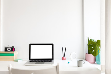 Laptop at trendy home office and books around, Homeschooling concept. Creative desk.	