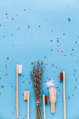 Bamboo wooden toothbrushes Isolated on blue background with lavender, aromatherapy oils