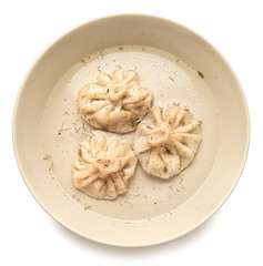 Plate with tasty dumplings on white background