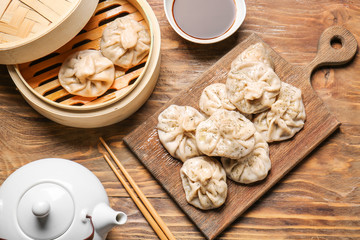 Tasty dumplings on wooden background