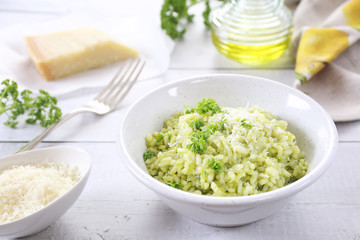 Italian cuisine. Parsley risotto, olive oil and Parmesan cheese