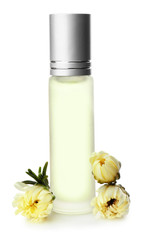 Bottle of floral roll-on perfume on white background