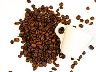 espresso on a bed of coffee.Roasted coffee beans background.Cup of coffee on beans