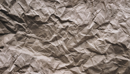 Crumpled vintage background from paper, which is used as a wrapper. The texture of cardboard made from recycled materials.