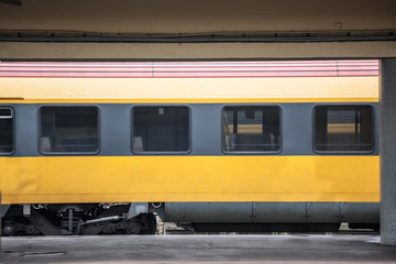 Fototapeta premium Passenger car abiding by European standards on standby, empty, in a typical platform of a train station in Europe. Railway travel is one of the biggest transportation mode in Europe.