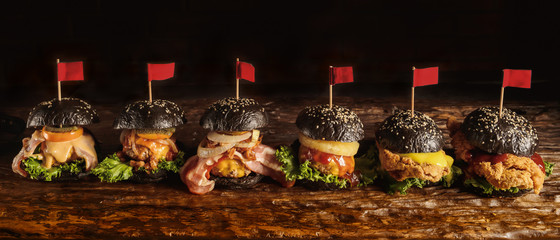 food background of assortment of black hamburger on wooden board, selective focused