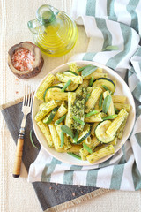 Penne pasta with roasted zucchini, pesto sauce and green beans, olive oil and sage dressing