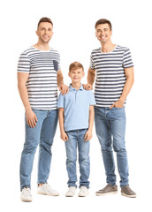 Happy gay couple with adopted child on white background