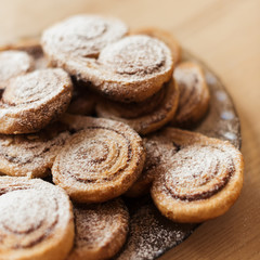 cookies homemade cakes in powdered sugar on a dark plate