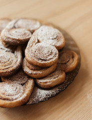 cookies homemade cakes in powdered sugar on a dark plate