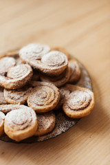 cookies homemade cakes in powdered sugar on a dark plate