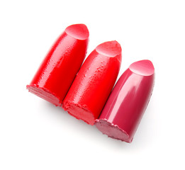 Samples of bright lipsticks on white background