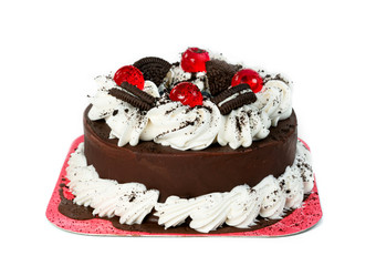 Chocolate cake with black cookie and whipped cream isolated on white background