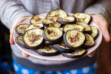 Baked roast or grill eggplants, aubergine slices with rucola herb. Vegan food lunch
