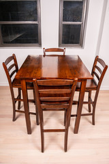 Wood table and chairs in a modern home, in the kitchen or breakfast nook.
