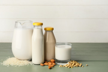 Different milk on wooden table