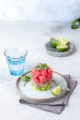 Tuna tartare tartar with avocado and quinoa. gourmet presentation with culinary ring on wite plate