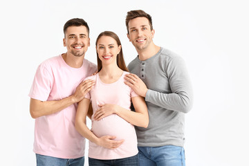 Gay couple with pregnant woman on white background