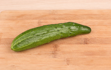Close up. Fresh ripe cucumber on a cutting board.