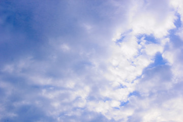 a photo of a cloud in the bright blue sky in the morning, looking very beautiful and charming.