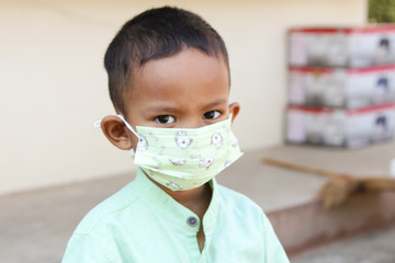 Little boy wearing a health mask. Conceptual Anti-virus Covid-19.  Dust prevention P2.5