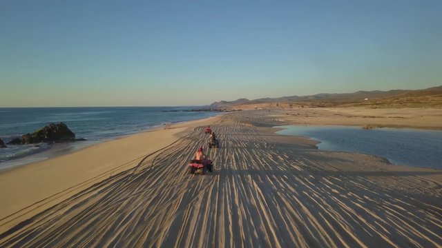 Riding Quad on Beach Sand. Group of People With ATV Activity in Cabo San Lucas,