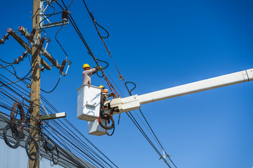 maintenance of electricians work with high voltage electricity on the hydraulic bucket