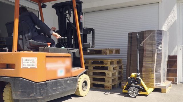Caucasian man industrial worker forklift driver driving empty pallet, 4K.