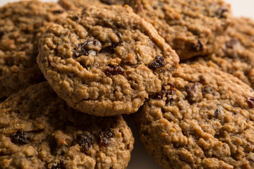 Fresh baked, Mouth watering Stacked oatmeal raisin cookies background. Sweet biscuits. Homemade sweetness.
