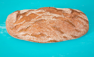 Rye bread on a blue background with selective focus