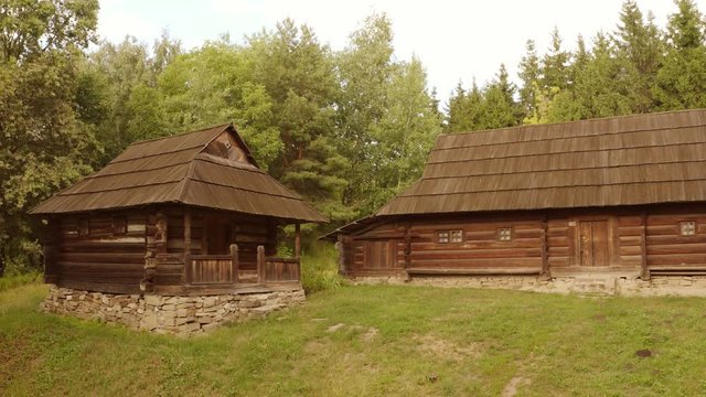 Two rustic wooden shack houses. Ancient medieval cabins in a forest.