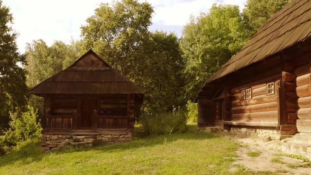 Ancient wooden medieval cabin houses. Old rustic shacks in a forest.