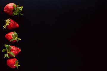strawberry fruit frame. black background. free space