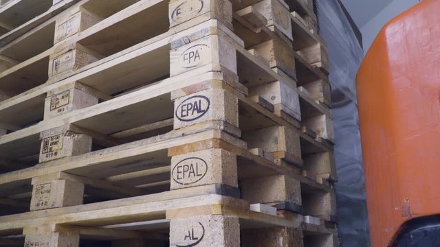 Industrial transportation, European standard EPAL pallets outside factory, close up shot.