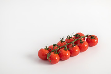 Ripe Fresh Cherry Tomatoes on Branch Isolated on White Background