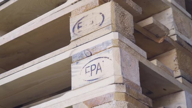 Industrial transportation, European standard EPAL pallets outside factory, close up shot.