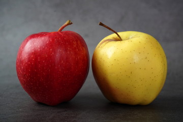 Red and yellow apples on a dark background